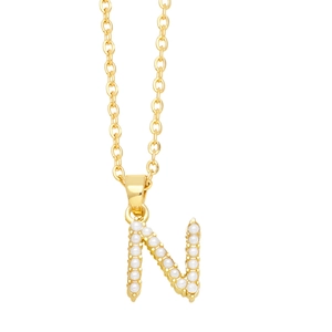 Close-up of gold letter N pendant featuring elegant white pearls on a delicate chain