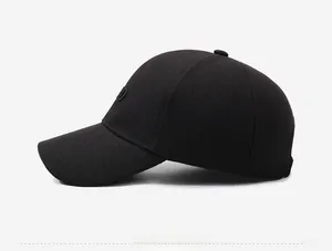 Detailed view of the side profile on a black baseball cap with embroidered CD lettering