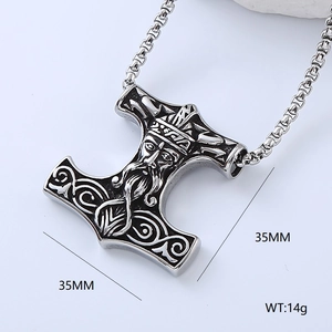 Macro detail of Mjolnir Thor hammer pendant featuring Viking carvings and metal etchings