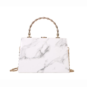 Trapezoid marble print handbag with gold bamboo handle and detachable chain strap