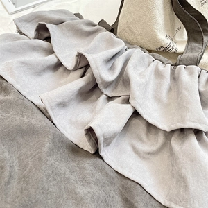 Detailed macro view of ruffled layered design and stitching on the bicolor hobo bag