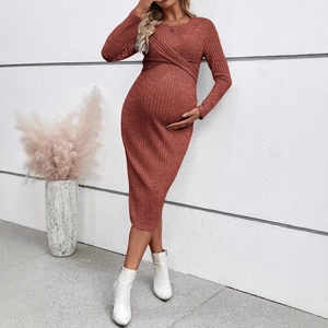 Rust red long sleeve maternity knit dress with twist front knot and ribbed texture