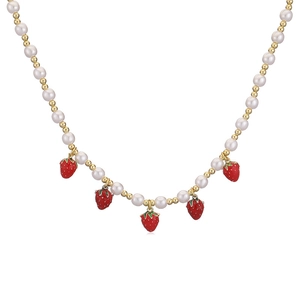 Sweet pearl necklace with red strawberry pendants and gold beads on a white background