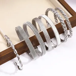 Silver woven titanium steel bangle set with twist and mesh patterns in minimalist style