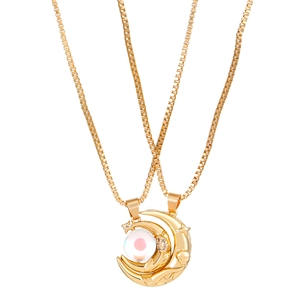 Detail of gold moon necklaces with magnetic sun and star charms for couples