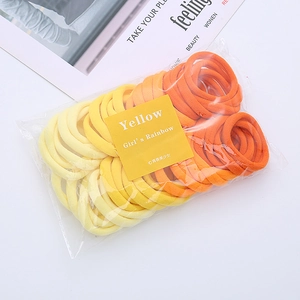 Detail of colorful seamless towel ring hair ties in a yellow gradient pack