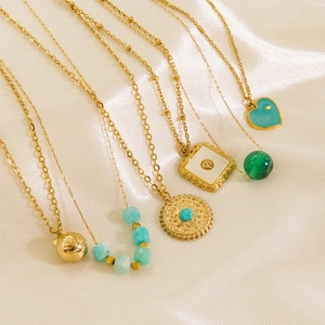 Bohemian gold plated necklaces with green turquoise and white shell pendants on satin