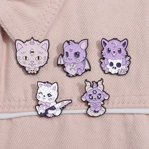 Close-up detail of five pastel goth enamel pins featuring creepy-cute purple cat designs