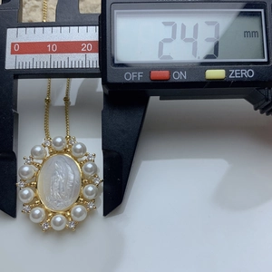 Detail showing the oval Mother of Pearl necklace pendant measuring 24.3mm with a digital caliper