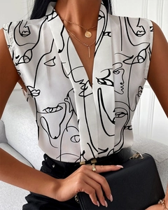 Detail of V-neck sleeveless white blouse with black abstract face art print on model
