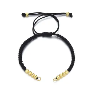 Adjustable black woven rope bracelet with gold beads and a sliding knot closure