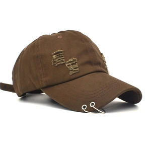 Brown distressed baseball cap with metal rings and ripped details in a side view