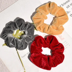 Golden velvet scrunchies in gray, yellow, and red colors with smooth silky texture