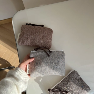 Mini herringbone tweed pouches in brown and grey for coins, earbuds and lipsticks