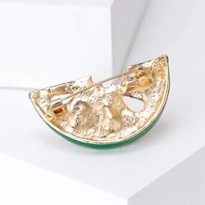 Detailed back view of golden watermelon slice brooch showing pin clasp and metal texture