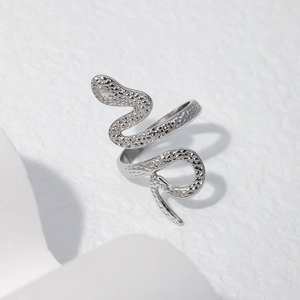 Detailed view of snake-shaped wrap ring featuring a unique hammered silver finish