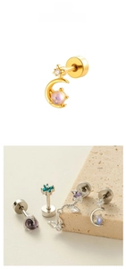 Detail of gold crescent moon cartilage piercing with micro-pave cubic zirconia on stone