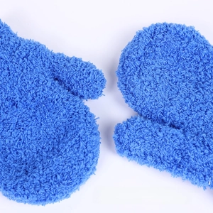 Close-up of soft coral fleece material on blue children's warm full-finger knit gloves