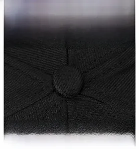 Macro detail of high-quality stitching and top button on a black cotton baseball cap