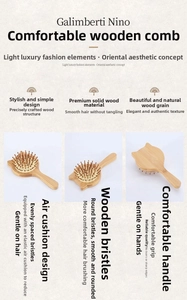 Detailed close-up of the cat-shaped bamboo hairbrush with rounded wooden massage bristles