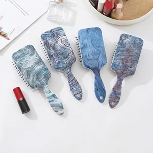 Square air cushion hairbrushes with wood texture print and marble patterns on white background