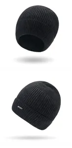 Detail view of the thick black ribbed knit beanie with silver SPORT metal emblem