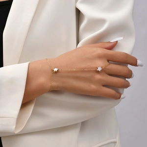 Elegant 14K gold star hand chain bracelet connected to ring on female model hand