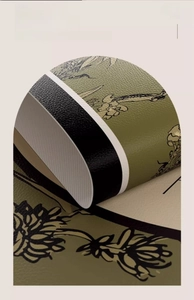 Macro detail of olive green leather placemat showing floral print and anti-slip backing