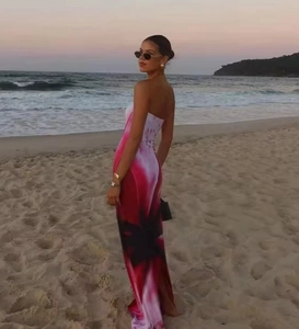 Maxi tube dress with pink and white abstract print on a sunset beach background