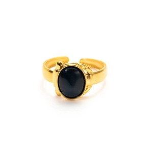 Macro shot of vintage gold adjustable ring featuring a polished oval black gemstone