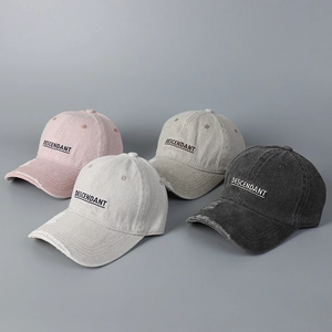 Detail of four distressed cotton baseball caps with embroidered letters and frayed brims