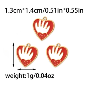 Macro detail of red enamel heart pendant with 1.3cm x 1.4cm size and 1g weight specs