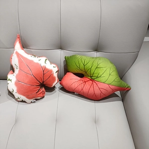 Macro detail of tropical leaf plush pillows with realistic patterns on a grey sofa