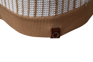 Macro detail of men's polo shirt showing brown striped knit and ribbed khaki hem texture
