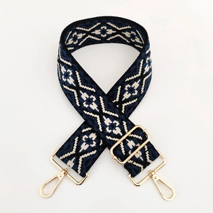 Close-up of ethnic jacquard strap with blue diamond pattern and gold metal hardware