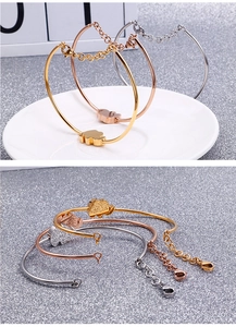 Detailed close-up of elephant charm bracelets in gold, rose gold and silver finishes
