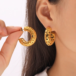 Chunky gold-plated C-shaped earrings with hollow organic texture in a minimalist design