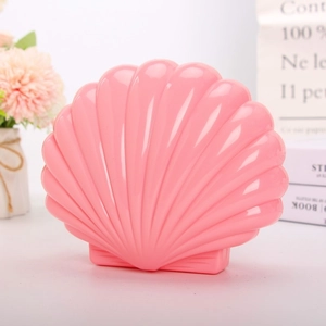 Detailed view of pink shell musical jewelry box with ballet dancer inside and soft lights