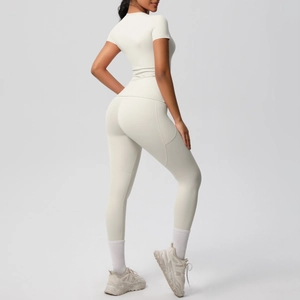 Detailed side view of high-waisted yoga leggings with practical side pockets and short sleeve top
