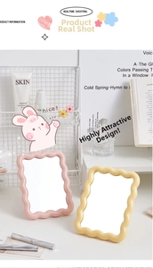 Pastel pink and yellow desktop makeup mirrors with wavy borders in a lifestyle setting