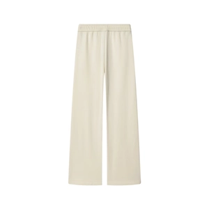 Detail view of cream high-waisted wide-leg trousers with elastic waistband and soft knit fabric