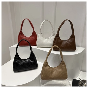 Detailed view of woven hobo bags in red, white, brown, and black colors on white steps