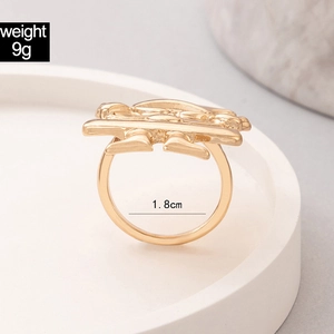 Detail shot of golden alloy logo ring on stone base with 1.8cm diameter and 9g weight
