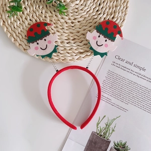 Festive Christmas headband featuring smiling elf ornaments with springs on a red fabric band