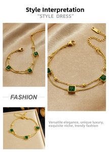 Macro detail of gold-plated double-layer chain bracelet with green square gemstone