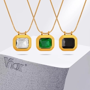 Minimalist gold necklace set with square clear, green, and black gemstone pendants