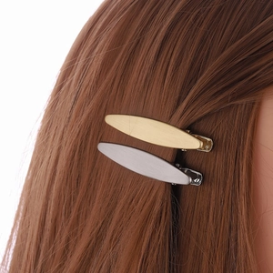 Minimalist gold and silver alloy duckbill hair clips with brushed texture on hair