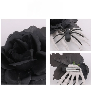Detail view of Halloween hair clip with black rose, skull hand, spider, and metal duckbill clip
