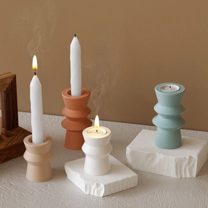 Minimalist Morandi ceramic candle holders with textured matte finish on stone pedestals