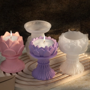 Lotus flower silicone candle mold with finished resin candle holders on wooden tray